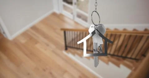 Image of silver key and key ring over blurred house interior Stock Photos
