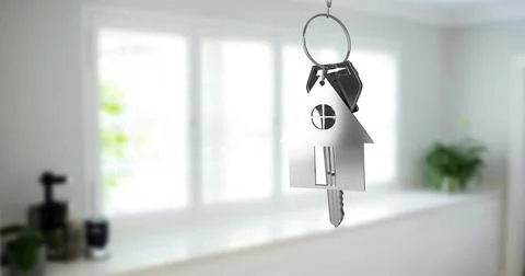 Image of silver key with key with key ring over blurred house interior Stock Photos