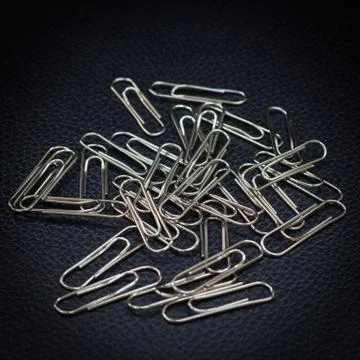 Image of silver paper clip isolated on white background Stock Photos