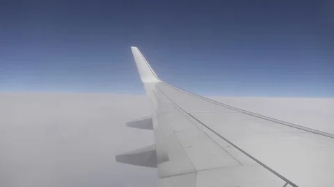 Image of the sky and clouds from a plane window during a flight. Stockbeeldmateriaal 109550111