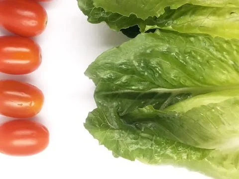 Image of small red tomatoes with green salad on white background isolate Stock Photos