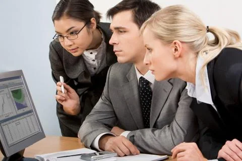 Image of smart work group staring at display of computer attentively Stock Photos