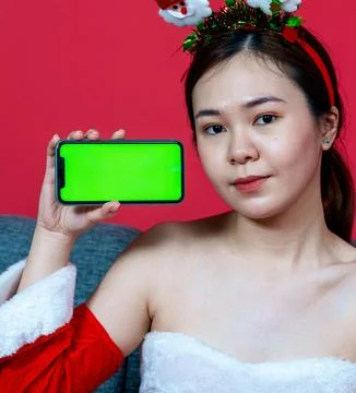 Image of a Smartphone With Green Colored Screen Held by a Woman With a Chri.. Stock Photos