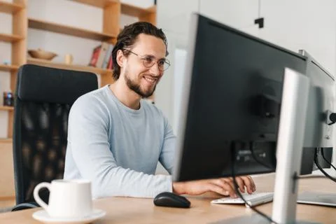 Image of smiling unshaven programmer man working with computer Stock Photos