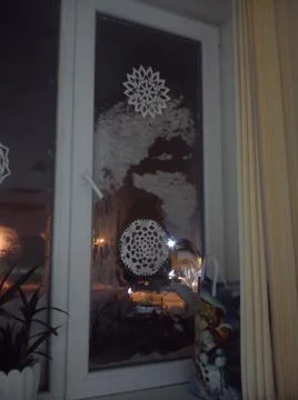 An image of snow face behind the window Stock Photos