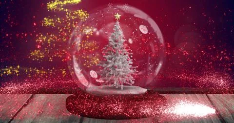 Image of snow falling and glowing spots over snow globe with tree on red Ilustração Stock