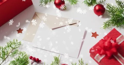 Image of snow falling over christmas decorations and envelopes Stock Illustration