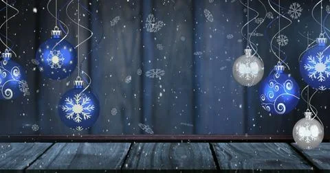 Image of snow falling over christmas baubles on blue background Stock Illustration