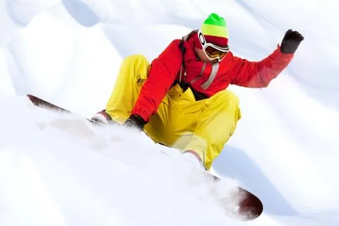 Image of snowboarder with holding his board during skating down Stock Photos