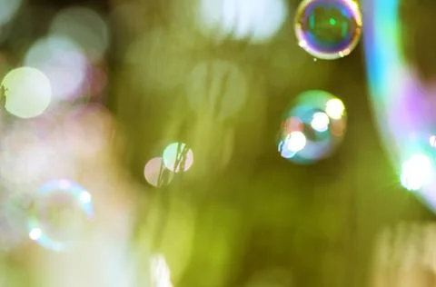 Image of soap bubbles over the green background Stock Photos