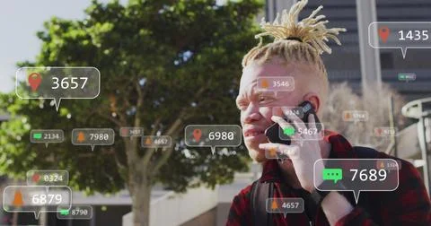 Image of social media data processing over albino man using smartphone in city Stock Photos