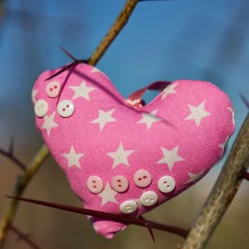 An image of a soft toy in the shape of a heart. Handicraft work. Stock Photos