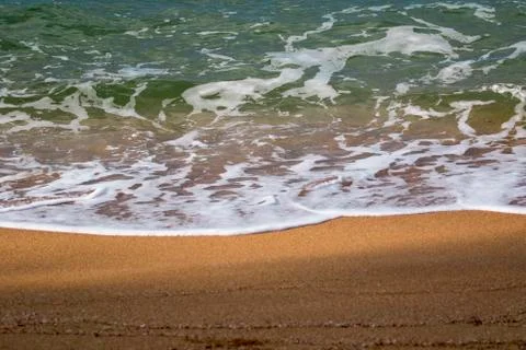 Image of soft wave of the sea on the sand beach. Stock Photos