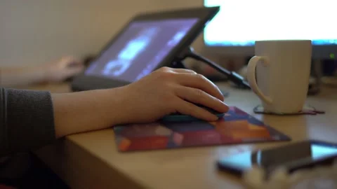 The image of someone's hand on a mouse, in the background a computer image Stock Footage 143831340