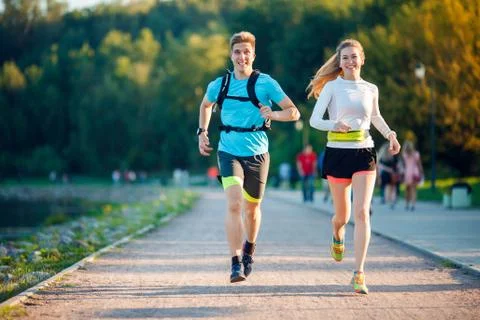 Image of sports men and women running in park Stock Photos