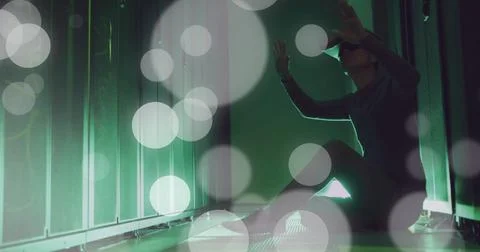 Image of spots of light and data processing over asian man using vr headset by Stock Photos