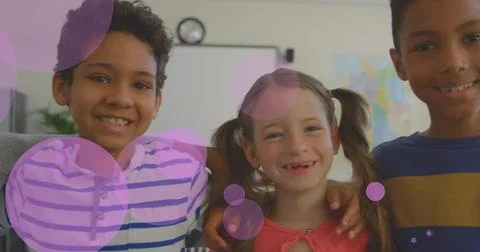 Image of spots of pink light over diverse school children Stock Photos