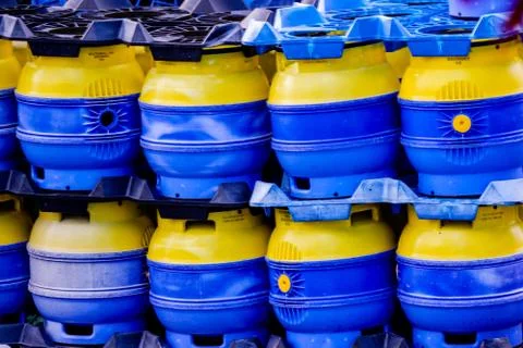 Image of a stack of blue and yellow beer barrels. Stock Photos