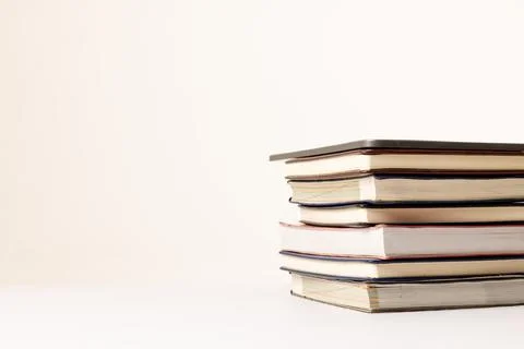 Image of stack of books on beige surface 写真素材