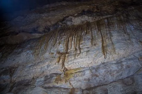 Image of stalactites on the wall in cave Stock Photos