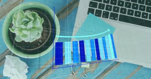 Image of statistical data processing against laptop, memo notes and plant on 库存照片