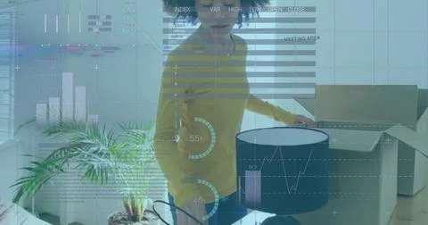 Image of statistical data processing against biracial couple unboxing items at Stock Photos