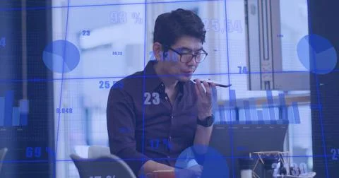 Image of statistical data processing against asian man talking on smartphone at Foto stock