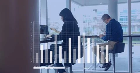 Image of statistics and data processing, diverse business people with computers Stock Photos