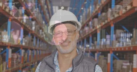 Image of statistics and data processing over smiling caucasian man working in Stockfoto's