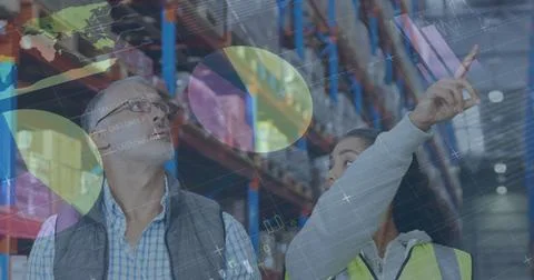 Image of statistics and financial data processing over man and woman working in Stock Photos
