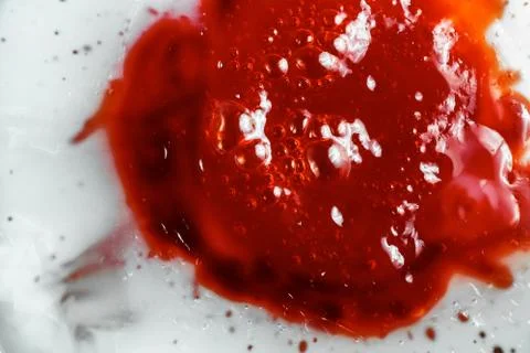 Image of sticky bubbled red liquid, close-up Stock Photos