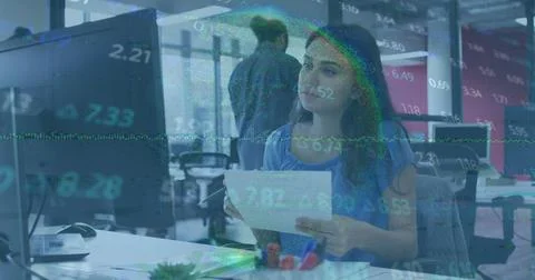 Image of stock market data processing against caucasian woman using computer at イラスト素材