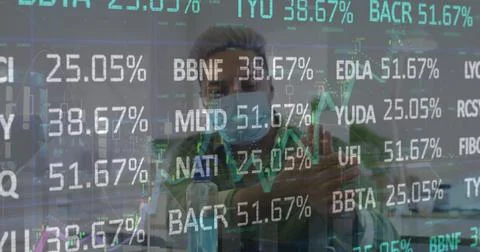 Image of stock market data processing over biracial man using hand sanitizer at Foto stock