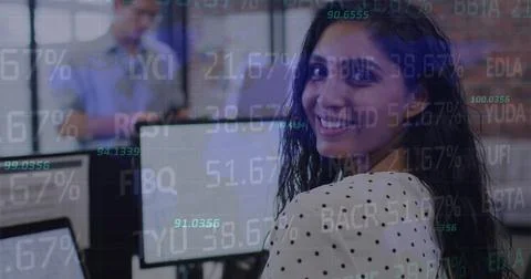 Image of stock market data processing over indian woman using computer at office 库存照片