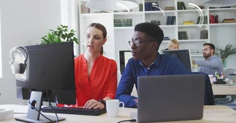Image of stock market data processing against diverse man and woman discuss.. Stock Photos