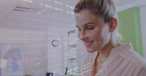 Image of stock market data processing over caucasian woman using digital tablet Foto stock
