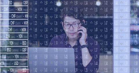 Image of stock market data processing against asian man talking on smartphone at Foto stock