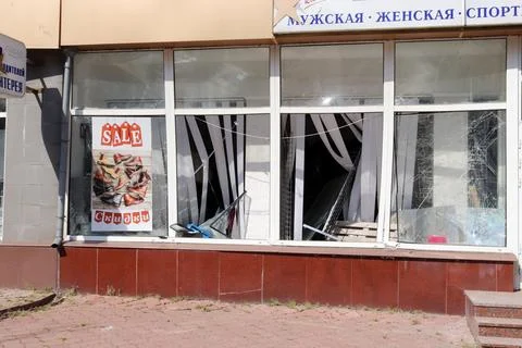 Image of a store with boarded up windows that stopped working due to close h.. Stock Photos