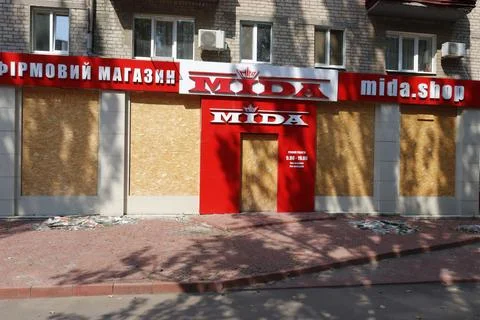 Image of a store with boarded up windows that stopped working due to close h.. Stock Photos