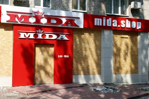 Image of a store with boarded up windows that stopped working due to close .. Stock Photos