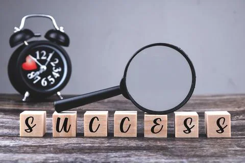 An image of success wording with selective focus image of magnifying glass on Stock Photos