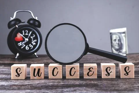 An image of success wording with selective focus image of magnifying glass on Stock Photos