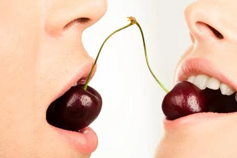 Image of succulent cherries in human mouths on a white background Stock Photos
