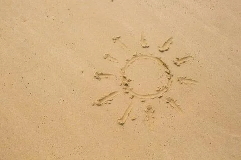 Image of sun drawing on sand Stock Photos