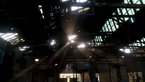 Image of sun rays crossing a scenic abandoned warehouse Stock Footage 148995909