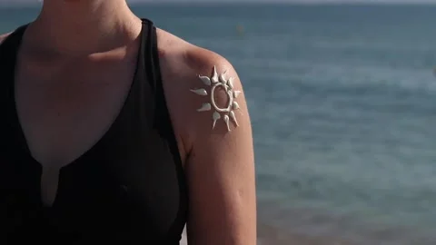 Image of the sun with sunscreen on a woman's shoulder Stock Footage 315533126