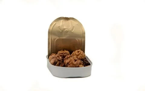 Image of a tin filled with walnut kernels. Stock Photos