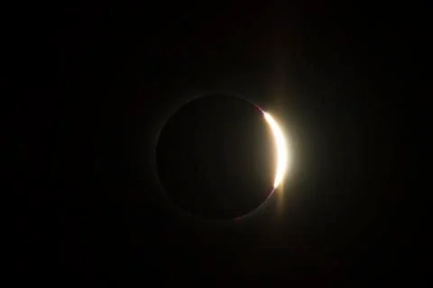 Image of a total solar eclipse taken with a telephoto lens. Right after totality Stock Photos
