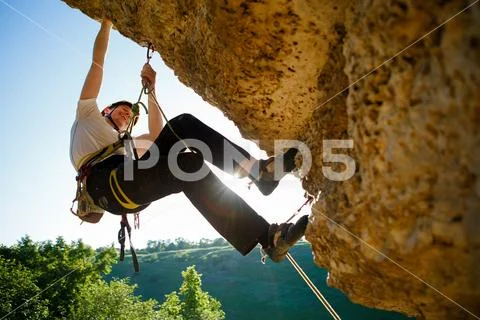 Image of tourist man in helmet clambering up Stock Photos