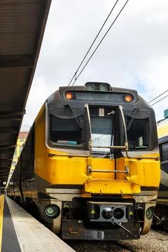 An image of a train sitting at a station platform. The platform is located in Stock Photos
